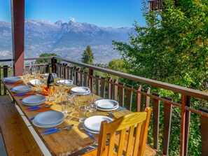 Enjoy a meal on the deck surrounded by lush greenery and breathtaking mountain views.