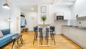A modern apartment with a living room, kitchen, and dining area.