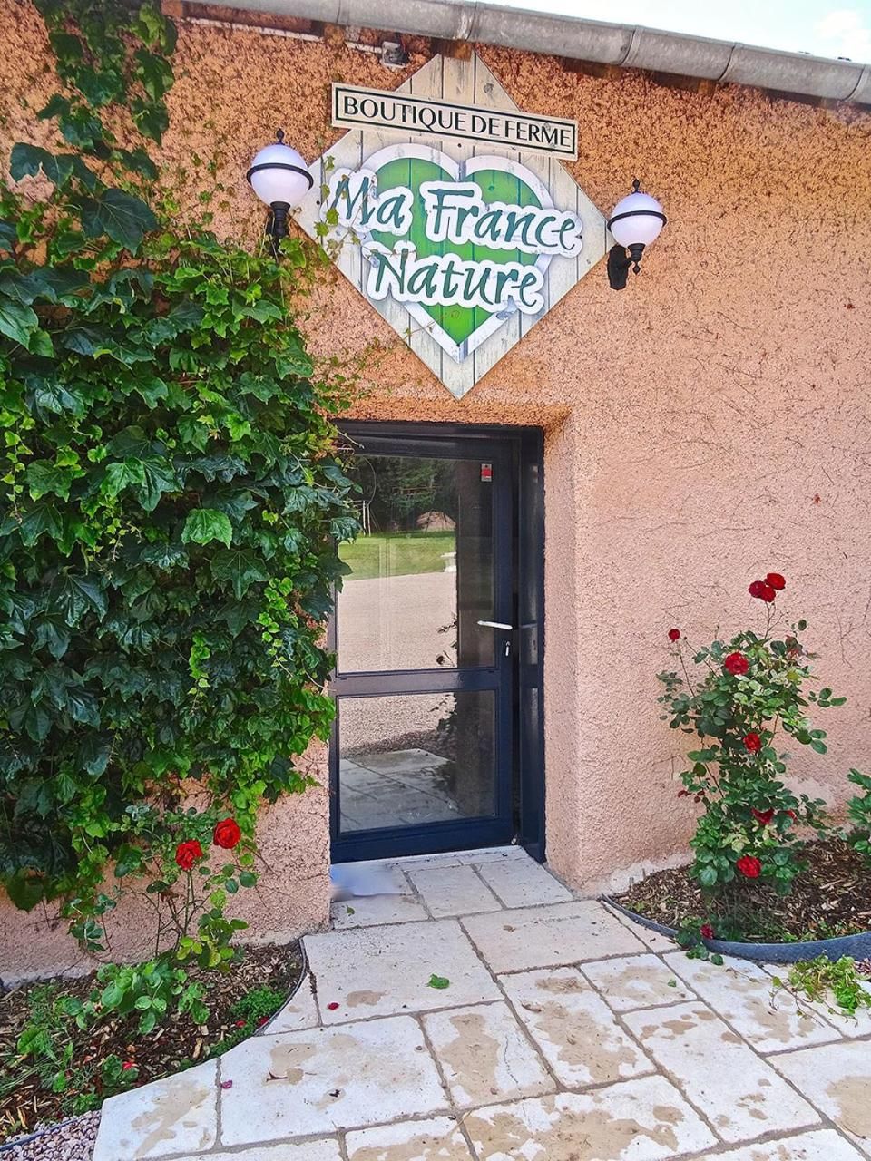 A boutique entrance with a sign reading 'Boutique de Ferme' and 'Ma France Nature.'