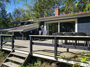 A wooden deck with outdoor seating and a covered area. - 14 Person Holiday Home in Nexo (Nexø)