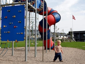 A playground with climbing structures and a slide.