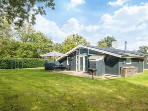 A house with a patio, a swing set, and a satellite dish. - 8 Person Holiday Home in Orsted (Ørsted)