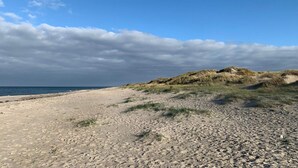 A beach with sand dunes and a clear sky. - 8 Person Holiday Home in Melby (Melby)