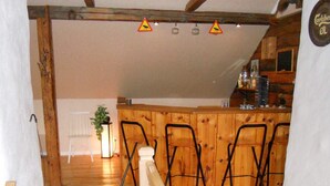 A wooden interior with a bar area, chairs, and a plant. - 6 Person Holiday Home in Ryssby (Ryssby)