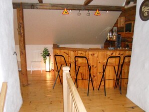 A wooden interior with a bar area, chairs, and a plant. - 6 Person Holiday Home in Ryssby (Ryssby)