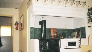 A kitchen with a stove, microwave, and a small refrigerator. - 6 Person Holiday Home in Ryssby (Ryssby)