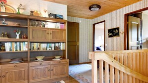 A cozy room with wooden furniture, a bookshelf, and a patterned rug. - 4 Person Holiday Home in Lysekil-by Traum (Lysekil)