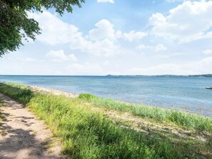 A coastal path with a clear view of the sea and distant land. - Simplistic Holiday Home in Blokhus With Sea Nearby (Aabenraa)