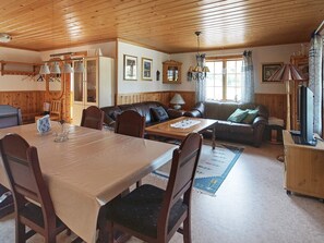 Relax in this inviting living space with a dining area, comfortable sofa, and TV.