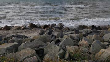 A rocky shoreline with waves crashing onto the rocks.