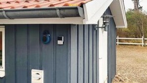 A building with a corrugated metal exterior, a small window, and a door. - 5 Star Holiday Home in Gorlev (Gørlev)
