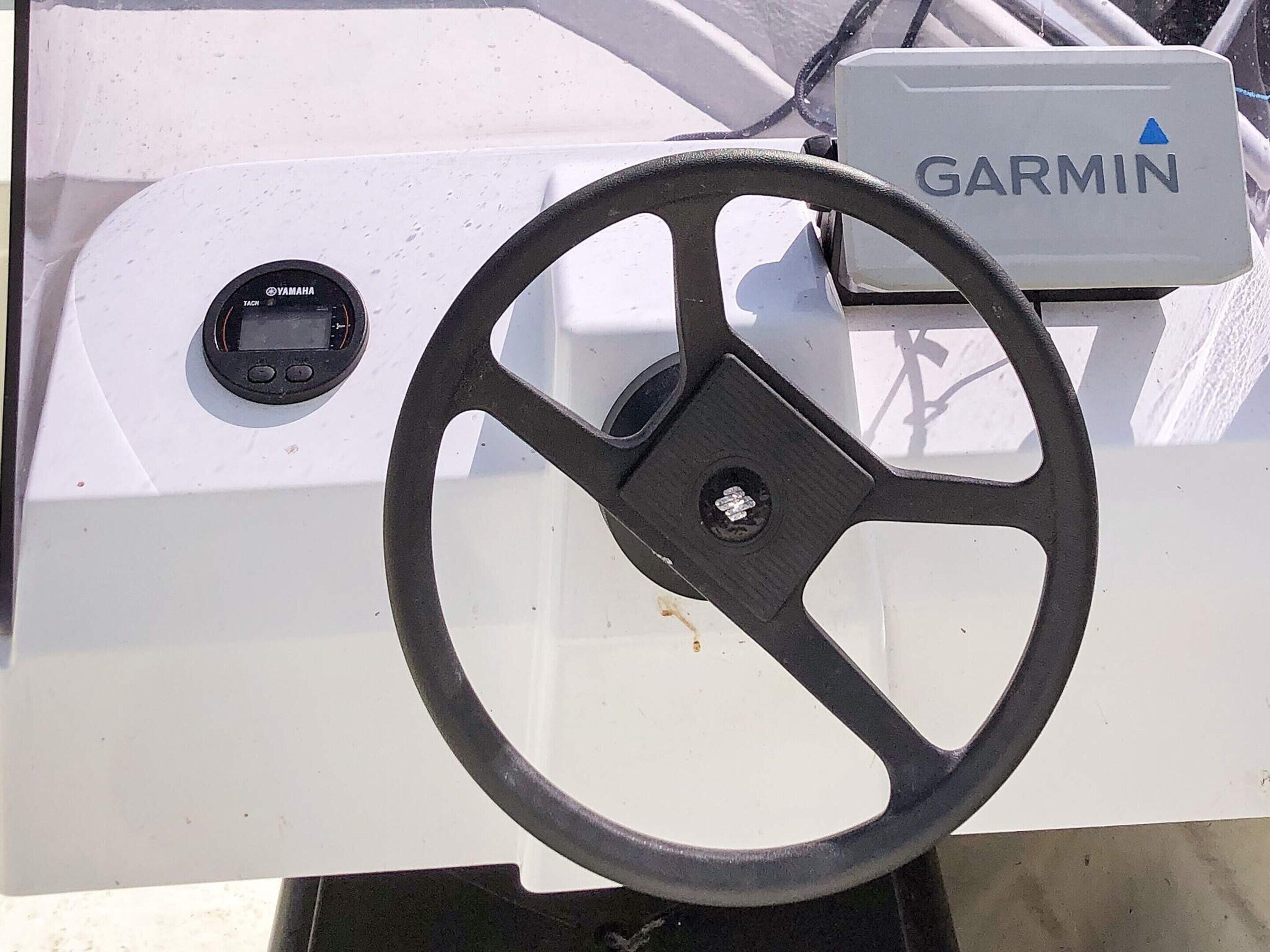 Un dispositivo de navegación Garmin fijado a una embarcación blanca.