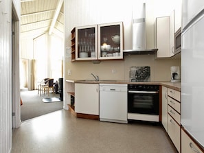 A compact kitchen with a dishwasher, oven, and a coffee maker. - Holiday Home in Otterndorf (Otterndorf)