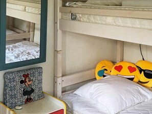 A bunk bed with a Mickey Mouse themed pillow and a framed picture on the lower bunk. - 6 Person Holiday Home in Aabenraa (Aabenraa)