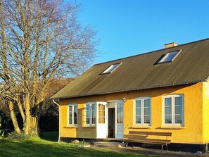 A yellow building with a sloped roof, a door, and windows. - 6 Person Holiday Home in Aabenraa (Aabenraa)