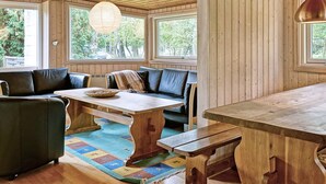 A cozy room with wooden walls, a bench, a table, and a sofa. - Cozy Holiday Home in Aakirkeby Bornholm near Sea (Akirkeby)