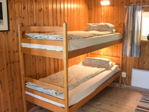 A bunk bed room with wooden walls and a small window. - 4 Person Holiday Home in Torsby (Torsby)