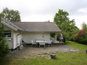 A house with a covered patio area, a white exterior, and a tiled roof. - 4 Star Holiday Home in Dronningmolle (Dronningmolle)