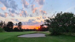 A golf course with a sand bunker and trees in the background. - 8 Person Holiday Home in Fjerritslev-by Traum (Fjerritslev)
