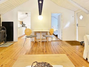 A compact living space with a dining area, kitchenette, and a cozy seating arrangement. - Holiday Home in Hallabro (Hallaröd)