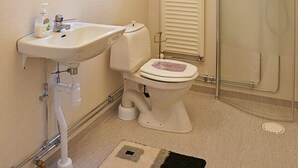 A bathroom with a sink, toilet, and shower.