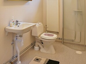 A bathroom with a sink, toilet, and shower. - 6 Person Holiday Home in Odensvi (Gamleby)