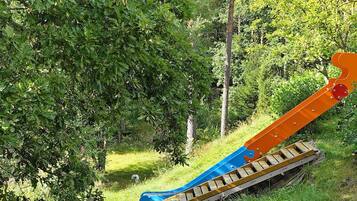 A playground with a slide and a small climbing structure.
