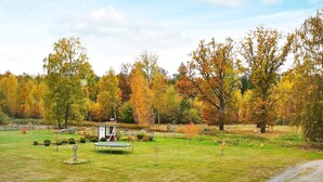 A park with a small gazebo, a trampoline, and a dirt path. - 5 Person Holiday Home in Lonashult (Lönashult)