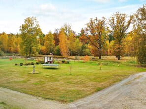 A rural landscape with a small gazebo, a dirt path, and autumn-colored trees. - 5 Person Holiday Home in Lonashult (Lönashult)