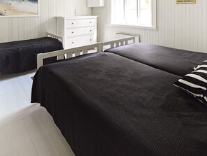 A bedroom with two beds, a white dresser, and a window. - 5 Person Holiday Home in Mariefred (Mariefred)