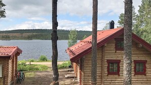 A log cabin with a red roof, a dock, and a lake view. - Holiday Home in SÃ¤len (Lima)