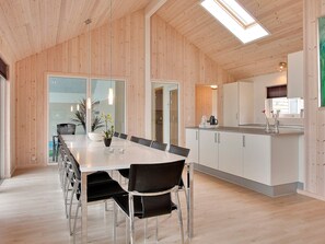 A modern kitchen with white cabinets, a stainless steel countertop, and a skylight. - 5 Star Holiday Home in Tisvildeleje (Tisvildeleje)