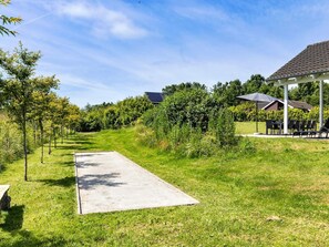 A pathway leading to a building with a covered outdoor seating area. - 5 Star Holiday Home in Tisvildeleje (Tisvildeleje)
