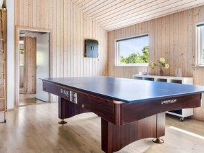 A billiards table in a room with wooden walls and a window. - 5 Star Holiday Home in Tisvildeleje (Tisvildeleje)