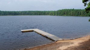 A lake with a wooden dock extending into the water. - 6 Person Holiday Home in Hacksvik (Håcksvik)