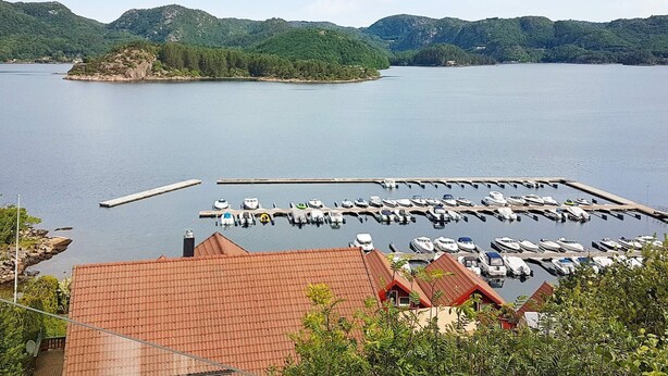 A marina with boats docked, surrounded by hills and a clear sky. - 10 Person Holiday Home in Lindesnes (Lindesnes)