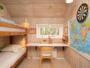 A bunk bed room with a desk, chair, lamp, and a dartboard. - 4 Star Holiday Home in Skagen (Skagen)