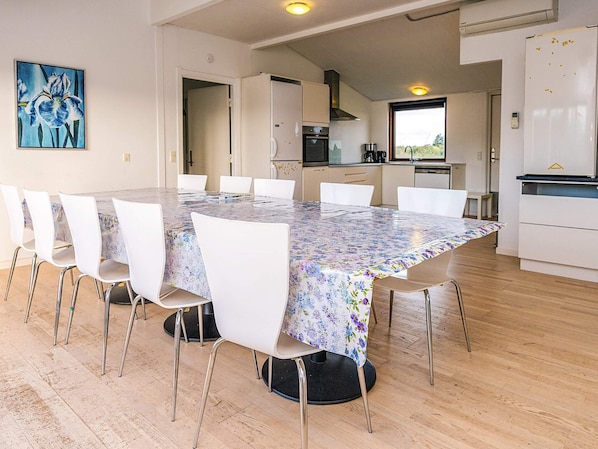 A modern kitchen with a dining area.