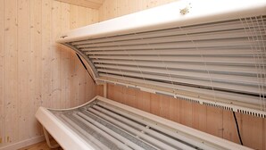 A sauna with a wooden interior and a bench. - 4 Star Holiday Home in Ringkobing (Ringkobing)