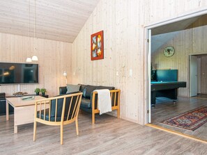 A room with a wooden ceiling, a television mounted on the wall, a pool table, and a door leading to another room. - 5 Star Holiday Home in Odder (Odder)