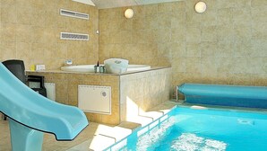 A bathroom with a bathtub, a shower, and a sink. - 5 Star Holiday Home in Odder (Odder)