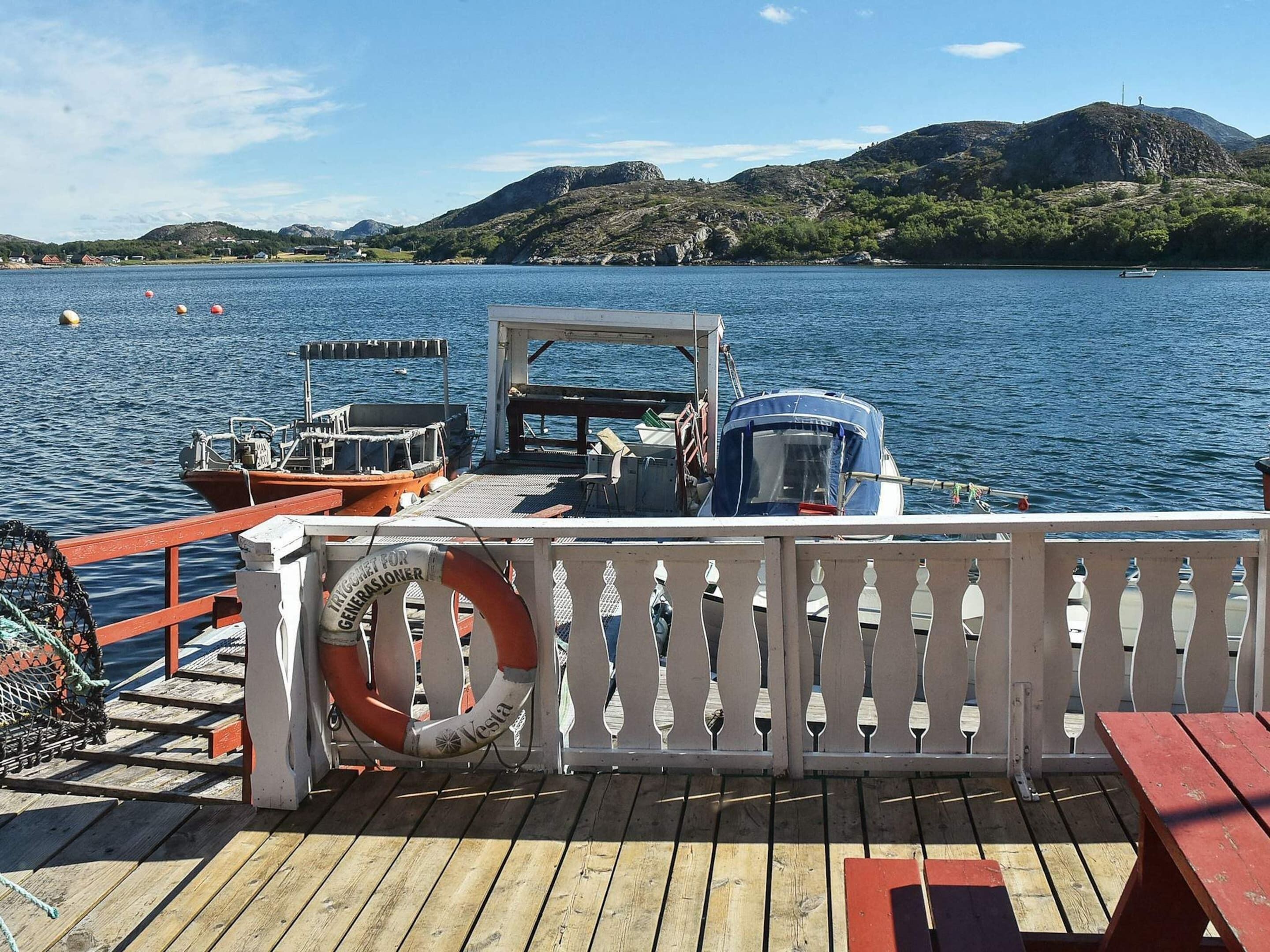 A boat docked at a pier with a lifebuoy and a sign reading 'TRIGGERT FOR GENEROSIONER'.