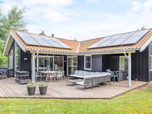 A modern house with a covered patio, solar panels, and a deck. - 4 Star Holiday Home in Hals (Hals)