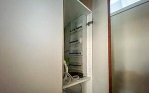 A room with a built-in shelf unit containing various items.