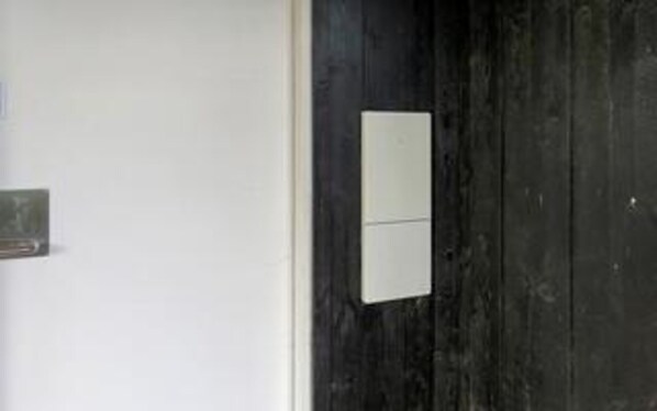 A door with a white panel and a small rectangular object on it.