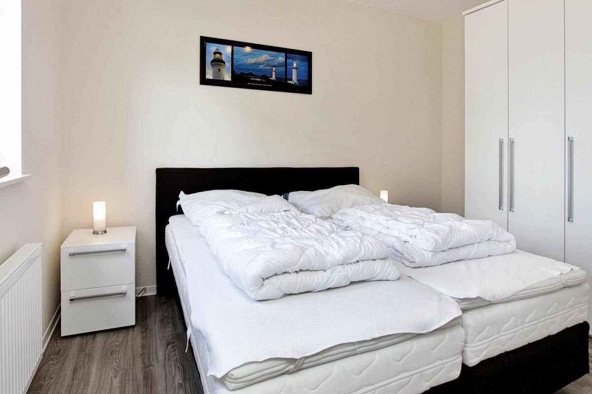 Relax in a stylish room with a double bed, nightstand, and wardrobe.