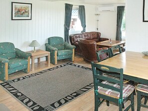 A living room with a sofa, chairs, a table, and a rug. - Holiday Home in Vevang (Hustadvika)