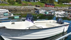 A small motorboat docked at a marina with a clear view of the surrounding area. - Holiday Home in Vevang (Hustadvika)
