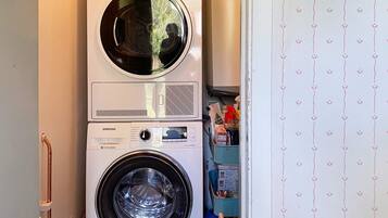 A stacked washer and dryer unit in a laundry room.