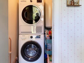 A stacked washer and dryer unit in a laundry room. - 6 Person Holiday Home in Ingatorp (Ingatorp)